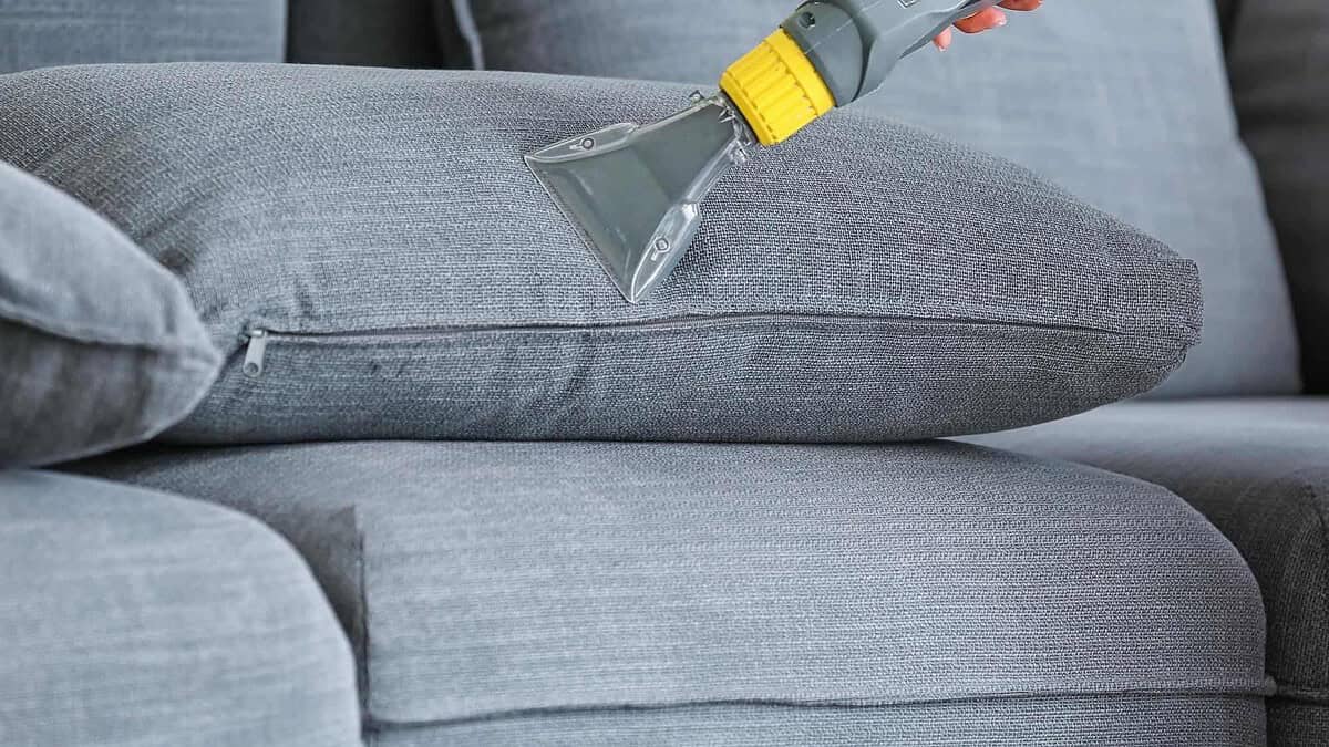 Steam cleaning sofa upholstery for fresh, spotless furniture.