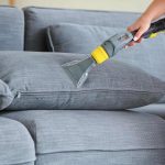 Sofa cleaning service in Singapore using upholstery extraction machine in a modern living room