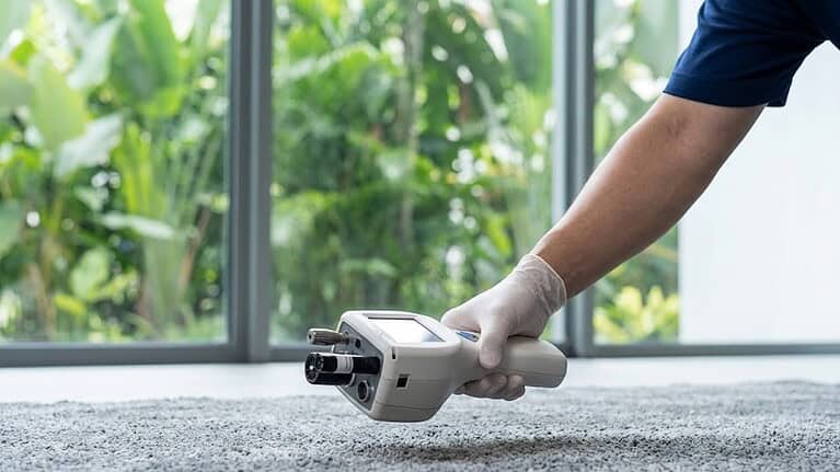 Professional technician testing Singapore carpet for dust mites, allergens, and microscopic dermatitis triggers.